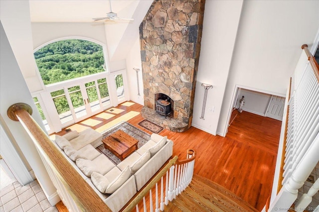 12 Fox Run, Sherman, CT 06784 - living area with high vaulted ceiling, ceiling fan, a wood stove, wood finished floors, and baseboards