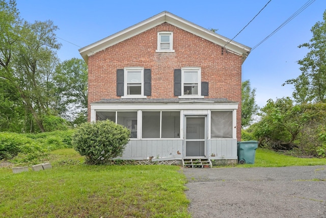 2914 State St, Hamden, CT 06517 - view of front of home featuring a sunroom, a front yard, and brick siding