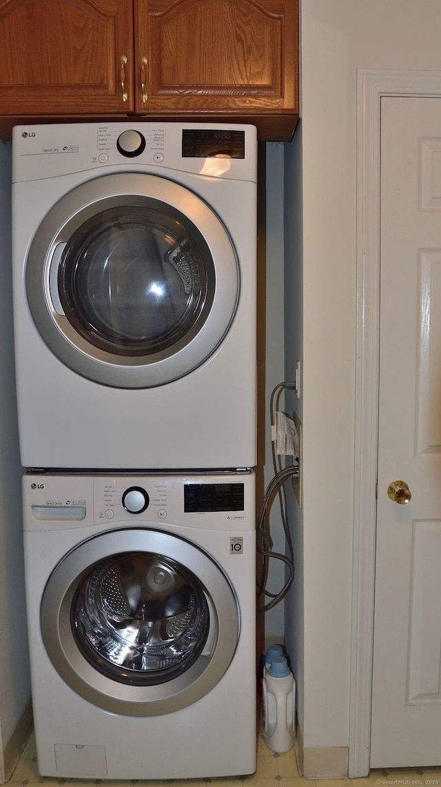 333 W Ave Unit 4, Milford, CT 06461 - laundry room with stacked washer / drying machine and cabinet space