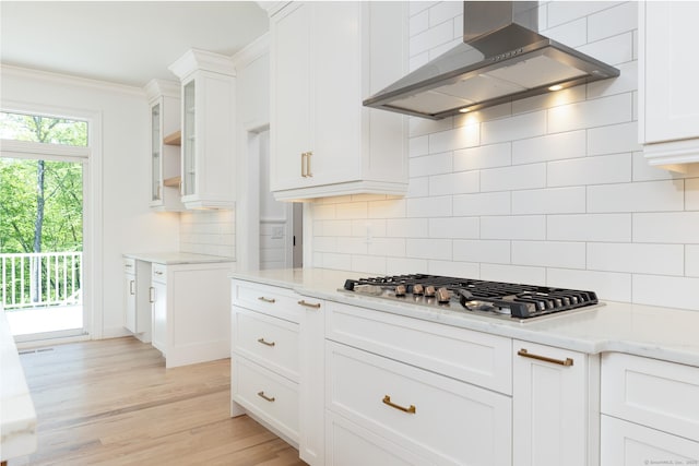 81 Nelson Dr, Burlington, CT 06013 - kitchen featuring wall chimney exhaust hood, white cabinets, stainless steel gas stovetop, and decorative backsplash