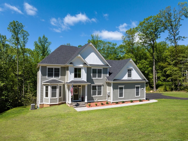 81 Nelson Dr, Burlington, CT 06013 - view of front facade featuring a front lawn, a shingled roof, and central AC