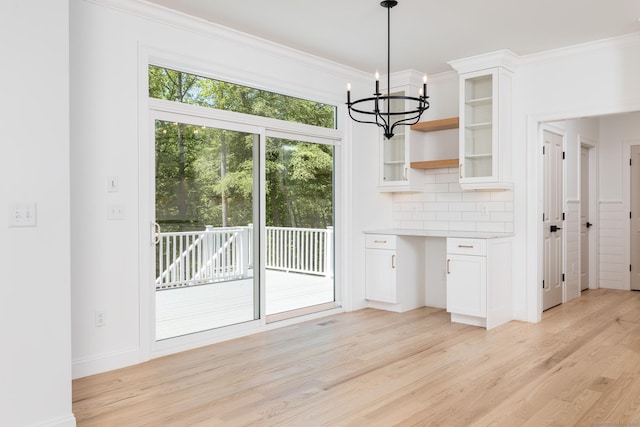 81 Nelson Dr, Burlington, CT 06013 - unfurnished dining area with light wood finished floors, a chandelier, ornamental molding, and baseboards