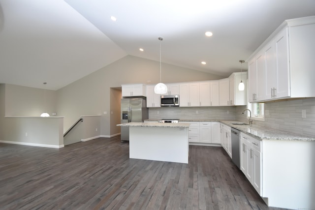 252 Plains Rd, Tolland, CT 06084 - kitchen featuring appliances with stainless steel finishes, a sink, vaulted ceiling, white cabinets, and a center island