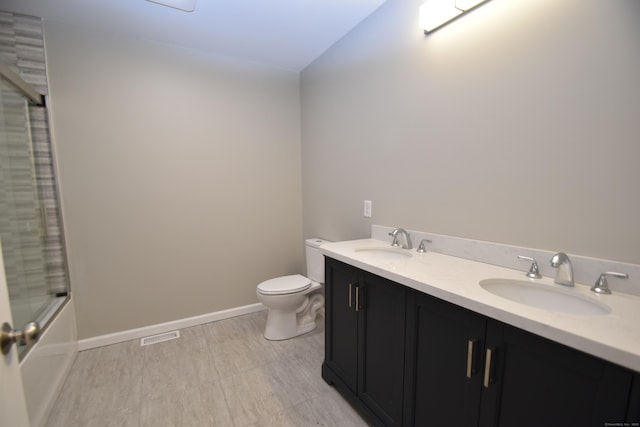252 Plains Rd, Tolland, CT 06084 - full bathroom with toilet, double vanity, combined bath / shower with glass door, and baseboards