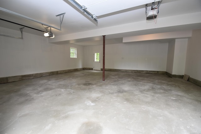 252 Plains Rd, Tolland, CT 06084 - garage featuring a garage door opener and baseboards
