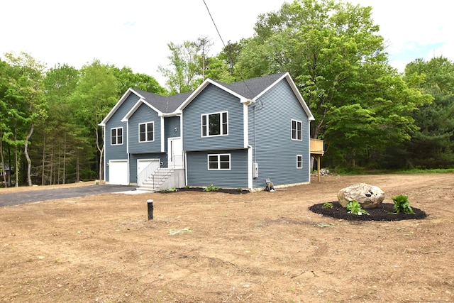 252 Plains Rd, Tolland, CT 06084 - bi-level home with asphalt driveway and an attached garage