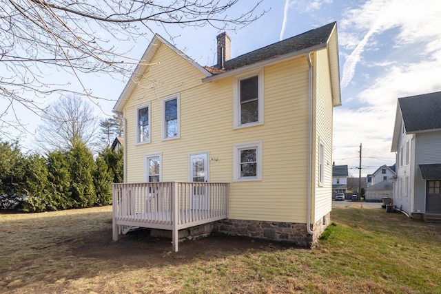 33 Prince St, Bristol, CT 06010 - rear view of house featuring a chimney, a lawn, and a wooden deck