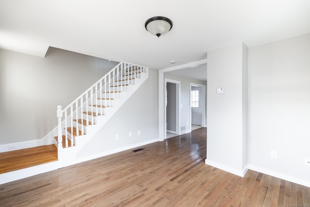33 Prince St, Bristol, CT 06010 - empty room featuring stairs, wood finished floors, and baseboards