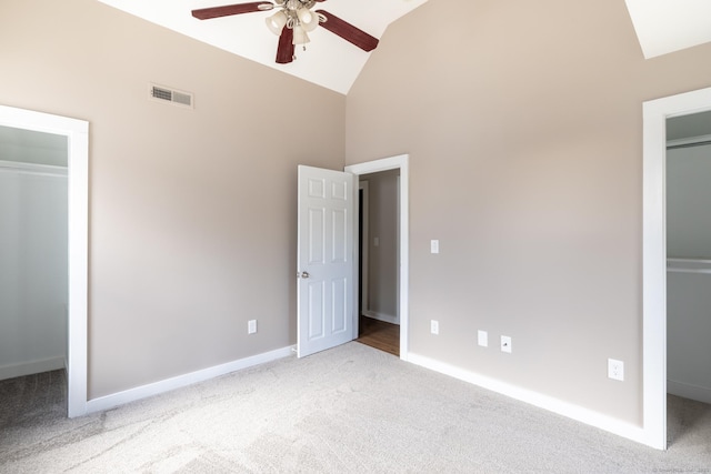 33 Prince St, Bristol, CT 06010 - unfurnished bedroom with a walk in closet, light carpet, high vaulted ceiling, a closet, and baseboards
