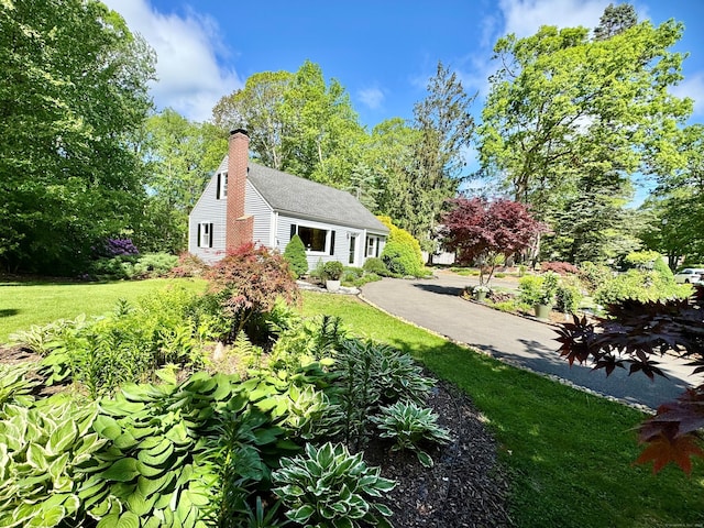 1 Russell Ln, Simsbury, CT 06070 - view of home's exterior with a yard and a chimney