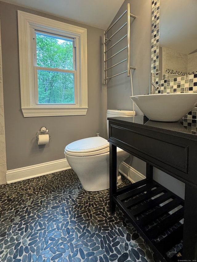 1 Russell Ln, Simsbury, CT 06070 - bathroom featuring toilet, stone flooring, tasteful backsplash, vaulted ceiling, and vanity