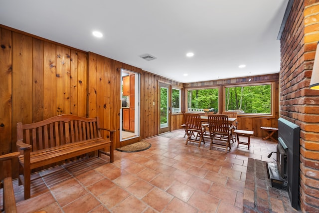 1 Russell Ln, Simsbury, CT 06070 - dining area with a wood stove, recessed lighting, and wood walls