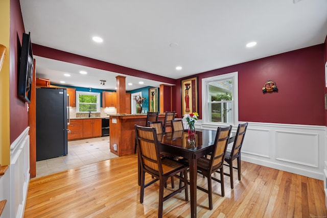 1 Russell Ln, Simsbury, CT 06070 - dining area featuring light wood-style floors, wainscoting, recessed lighting, and a decorative wall