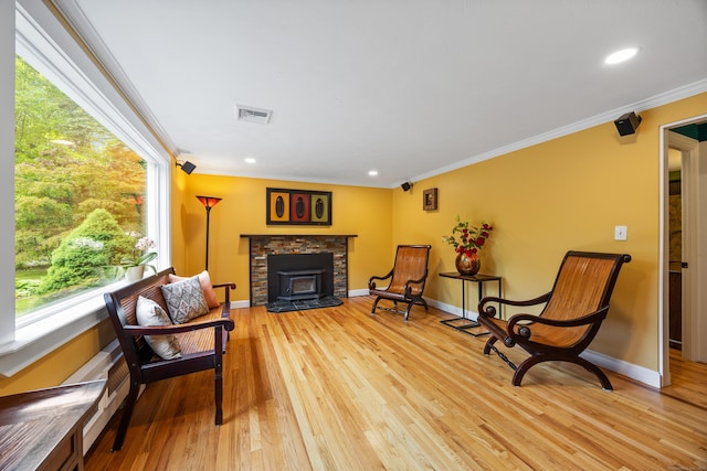 1 Russell Ln, Simsbury, CT 06070 - sitting room with light wood finished floors, ornamental molding, baseboards, recessed lighting, and a wood stove