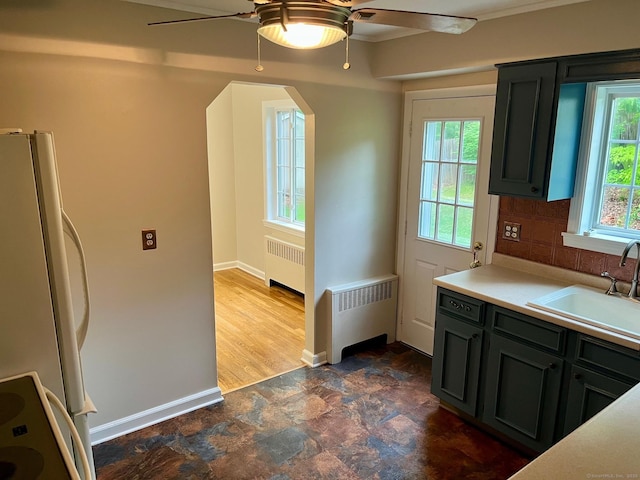 219 French St, Bristol, CT 06010 - kitchen with radiator heating unit, a sink, freestanding refrigerator, and a ceiling fan
