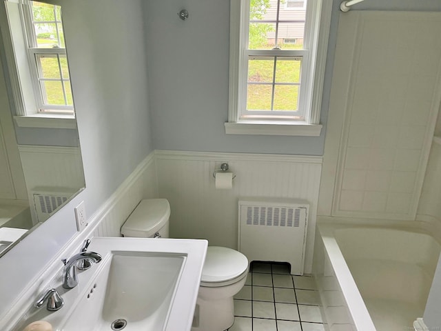 219 French St, Bristol, CT 06010 - bathroom featuring radiator, toilet, a sink, wainscoting, and tile patterned flooring