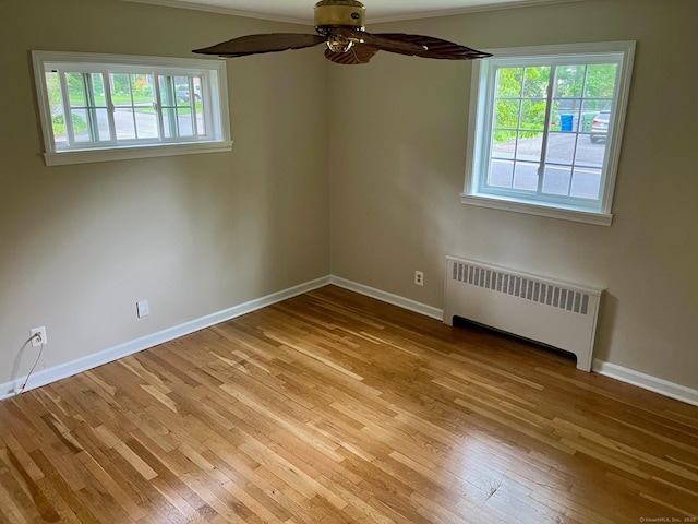 219 French St, Bristol, CT 06010 - unfurnished room with radiator heating unit, light wood-type flooring, baseboards, and ceiling fan