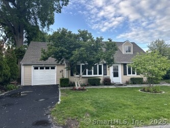 16 Neponsit St, Stamford, CT 06902 - view of front facade with a garage, asphalt driveway, and a front yard