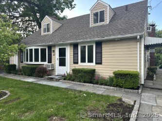 16 Neponsit St, Stamford, CT 06902 - cape cod house with a front yard and a shingled roof