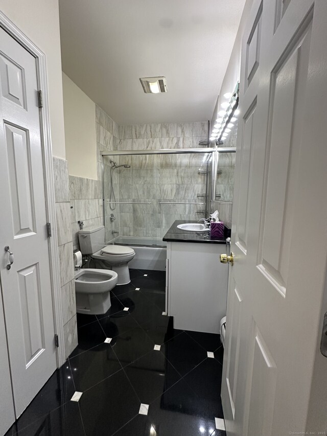 16 Neponsit St, Stamford, CT 06902 - full bath featuring tile walls, toilet, vanity, tiled shower / bath combo, and tile patterned flooring