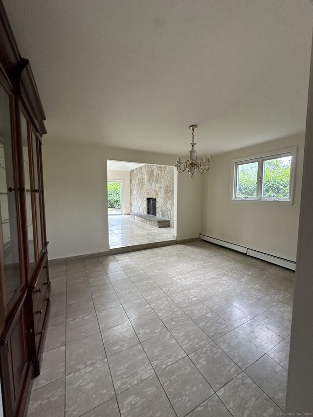 16 Neponsit St, Stamford, CT 06902 - unfurnished living room with a chandelier, baseboard heating, tile patterned floors, a stone fireplace, and baseboards