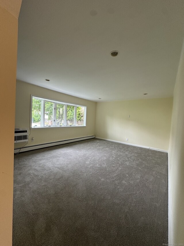 16 Neponsit St, Stamford, CT 06902 - spare room featuring a baseboard heating unit, carpet flooring, baseboards, and a wall unit AC