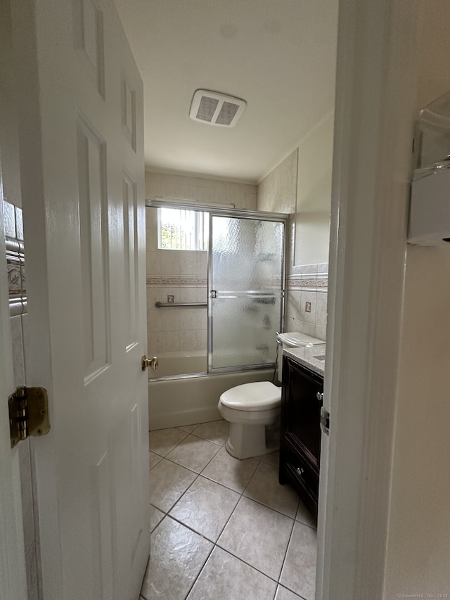 16 Neponsit St, Stamford, CT 06902 - full bathroom with vanity, toilet, enclosed tub / shower combo, tile walls, and tile patterned flooring