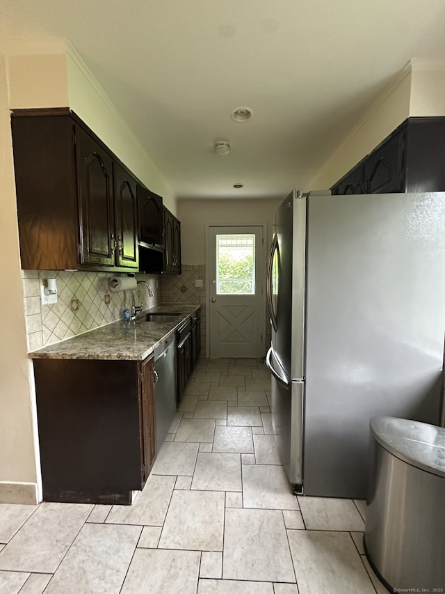 16 Neponsit St, Stamford, CT 06902 - kitchen with stainless steel appliances, a sink, tasteful backsplash, dark brown cabinetry, and light stone countertops