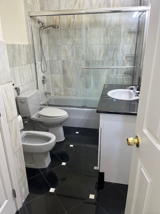 16 Neponsit St, Stamford, CT 06902 - bathroom with tile walls, tile patterned flooring, vanity, bath / shower combo with glass door, and a bidet