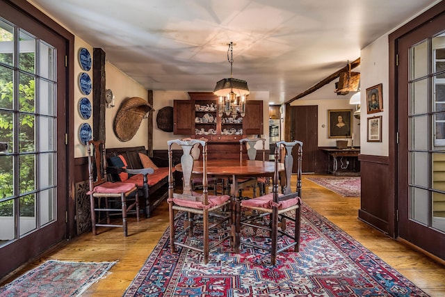 30 Meeting House Ln, Madison, CT 06443 - dining area with a chandelier, light wood-style floors, and wainscoting