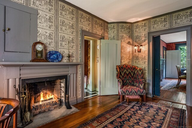 30 Meeting House Ln, Madison, CT 06443 - living area featuring hardwood / wood-style flooring, a warm lit fireplace, and ornamental molding