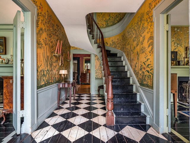 30 Meeting House Ln, Madison, CT 06443 - stairs with wallpapered walls, wainscoting, and a decorative wall