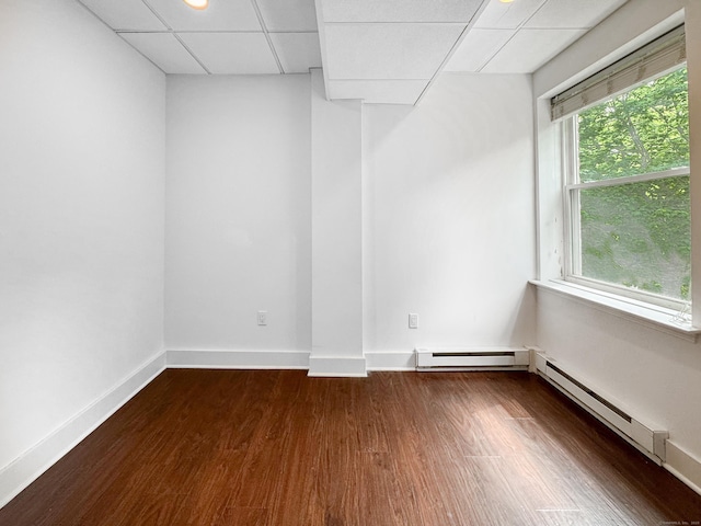 70 Strawberry Hill Ave Unit 5Gr4, Stamford, CT 06902 - spare room with a drop ceiling, baseboard heating, dark wood-style floors, and baseboards