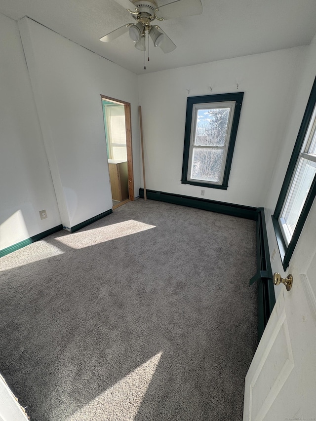 7 Carver Ave, Norwich, CT 06360 - empty room with plenty of natural light, ceiling fan, carpet, and baseboards