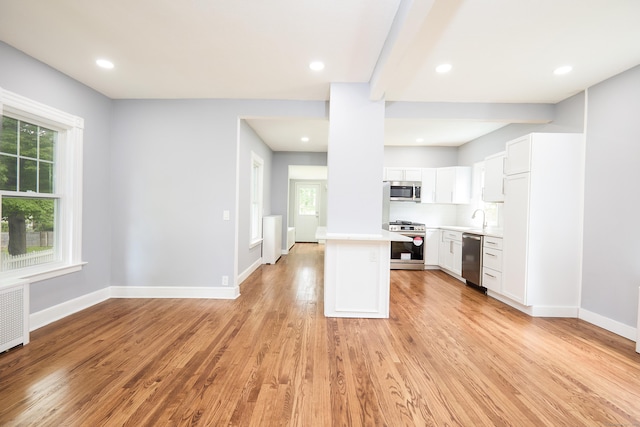 314 Skiff St, North Haven, CT 06473 - kitchen with stainless steel appliances, light countertops, light wood-type flooring, white cabinetry, and baseboards