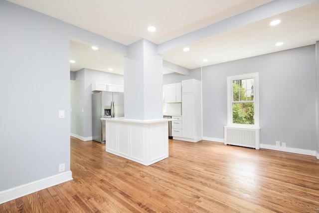 314 Skiff St, North Haven, CT 06473 - unfurnished living room featuring radiator heating unit, light wood-style flooring, baseboards, and recessed lighting