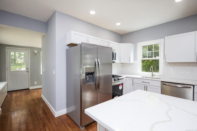 314 Skiff St, North Haven, CT 06473 - kitchen with stainless steel appliances, a sink, light stone counters, backsplash, and recessed lighting
