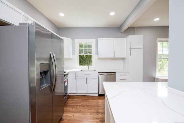 314 Skiff St, North Haven, CT 06473 - kitchen featuring stainless steel appliances, a sink, light stone counters, plenty of natural light, and recessed lighting