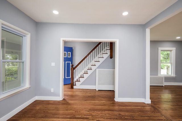 314 Skiff St, North Haven, CT 06473 - entrance foyer with wood finished floors, baseboards, stairs, recessed lighting, and radiator