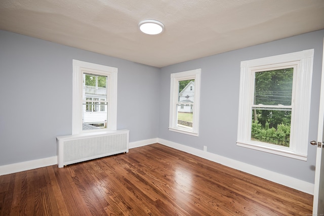 314 Skiff St, North Haven, CT 06473 - spare room featuring radiator heating unit, baseboards, wood finished floors, and plenty of natural light