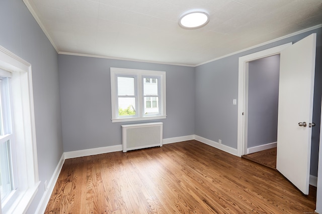 314 Skiff St, North Haven, CT 06473 - spare room featuring radiator, crown molding, wood finished floors, and baseboards