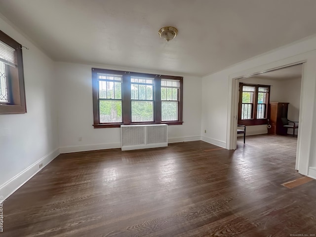26 Stoehrs Pl, Bridgeport, CT 06606 - empty room featuring radiator heating unit, dark wood finished floors, and baseboards