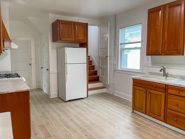 26 Stoehrs Pl, Bridgeport, CT 06606 - kitchen featuring white appliances, a sink, brown cabinetry, baseboards, and light countertops