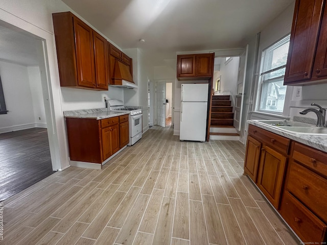 26 Stoehrs Pl, Bridgeport, CT 06606 - kitchen with white appliances, premium range hood, and light wood-type flooring