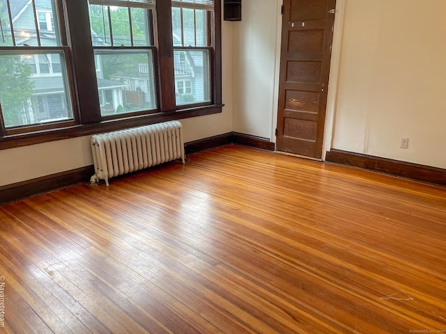 26 Stoehrs Pl, Bridgeport, CT 06606 - empty room featuring radiator, light wood-type flooring, and baseboards