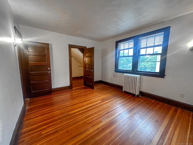 26 Stoehrs Pl, Bridgeport, CT 06606 - unfurnished bedroom featuring radiator, wood-type flooring, and baseboards