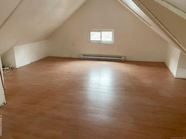 26 Stoehrs Pl, Bridgeport, CT 06606 - bonus room featuring a baseboard radiator, light wood-type flooring, and lofted ceiling