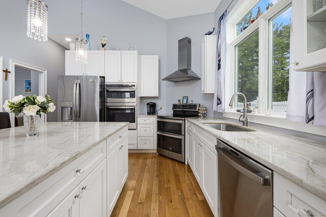 194 Killdeer Rd, Webster, MA 01570 - kitchen with stainless steel appliances, wall chimney range hood, a sink, and white cabinetry