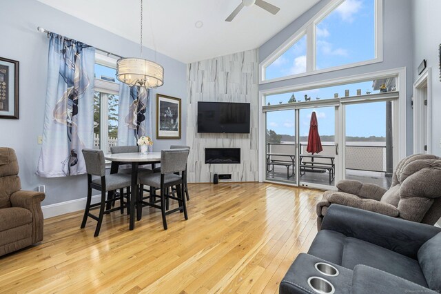 194 Killdeer Rd, Webster, MA 01570 - living area featuring wood-type flooring, a fireplace, plenty of natural light, high vaulted ceiling, and a ceiling fan