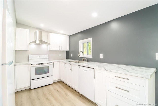 13 Turner Rd, Litchfield, CT 06778 - kitchen with wall chimney exhaust hood, white appliances, a sink, a peninsula, and white cabinetry